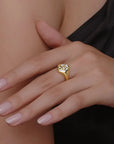 Gold ring with diamonds on a hand against a neutral background