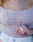 model wearing 3 silver necklaces and 3 rings