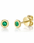 Gold earrings with round emeralds on a white background