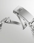 Silver watch band on a light gray background