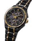 Black and gold Seiko Astron watch on a white background angled close up