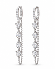 A pair of silver huggie hoop earrings with dangling chains and marquise-cut clear gemstones, shown on a plain white background.