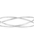 Silver bracelet with a crossover wire design on a white background