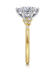 Gold and silver ring with diamond-like stones on a white background