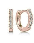Rose gold hoop earrings with diamond gemstones on a white background