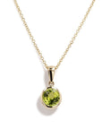 14K yellow gold round 7mm peridot bezel pendant, 1.46 carats, front view; chain shown for styling only