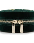 Green velvet jewelry box with gold zipper on a white background