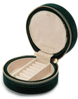 Round black velvet case with beige inside compartments for rings and side compartments
