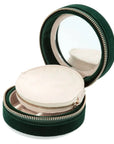 Green round jewelry box with mirror lid on a white background