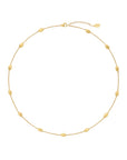 Gold necklace on a light beige background
