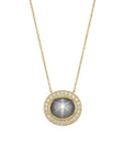 A custom-made 14K yellow gold pendant necklace by Skeie's Jewelers, featuring an oval 4.61 carat gray-blue star sapphire cabochon displaying a prominent six-rayed star, surrounded by a 0.33 carat round diamond halo on an 18-inch chain.
