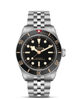 Tudor watch with black dial and silver bracelet on a white background