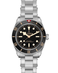 Tudor watch with black dial and silver open bracelet on a white background