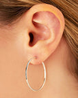 White Gold Tube Hoop Earrings by Carla | Nancy B.