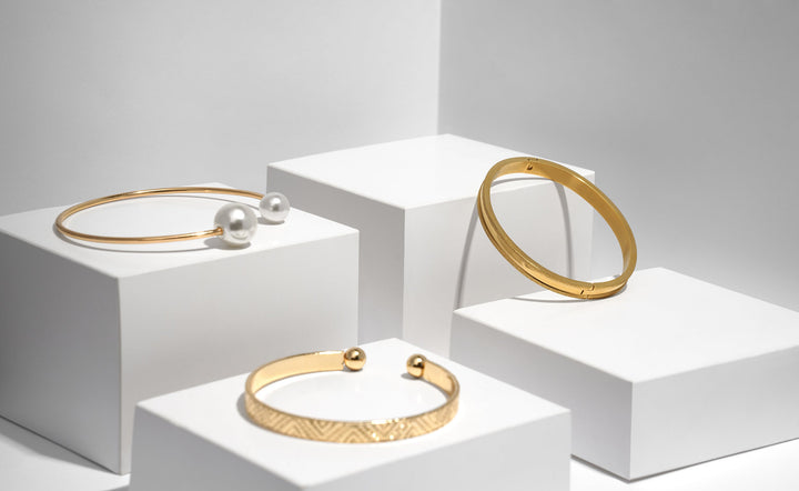 3 gold bracelets on a display