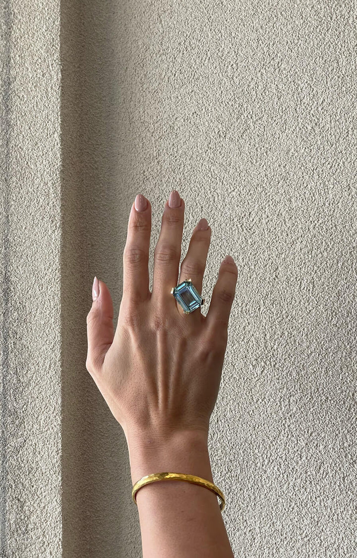 Hand with a large aquamarine gemstone ring