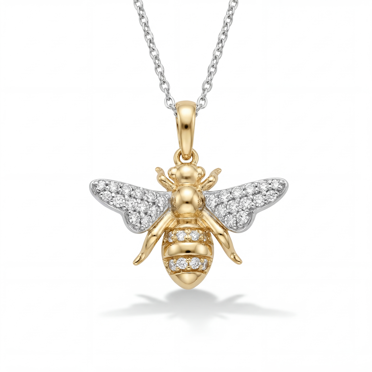 Gold bee pendant with diamond accents on a white background front view
