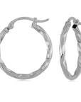 white gold hoops with twisted design on a white background