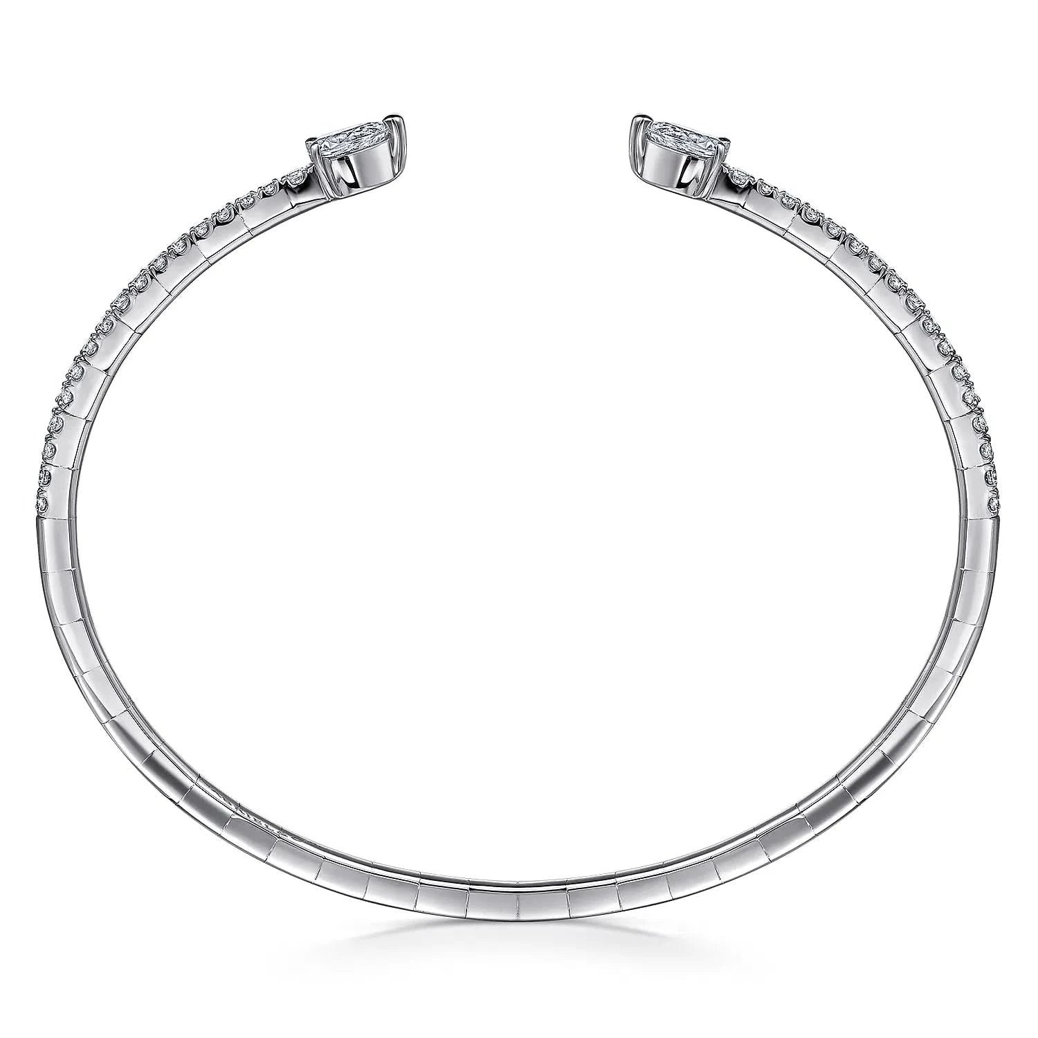 A white gold open bangle bracelet with a row of small pavé-set stones along the band and a larger central stone at each end, shown on a plain white background. side view