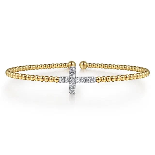 Gold bracelet with a diamond-cross design on a white background