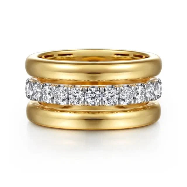 Gold ring with diamond-studded band on a white background