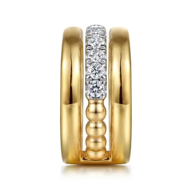 Two gold rings with diamond accents in between on a white background