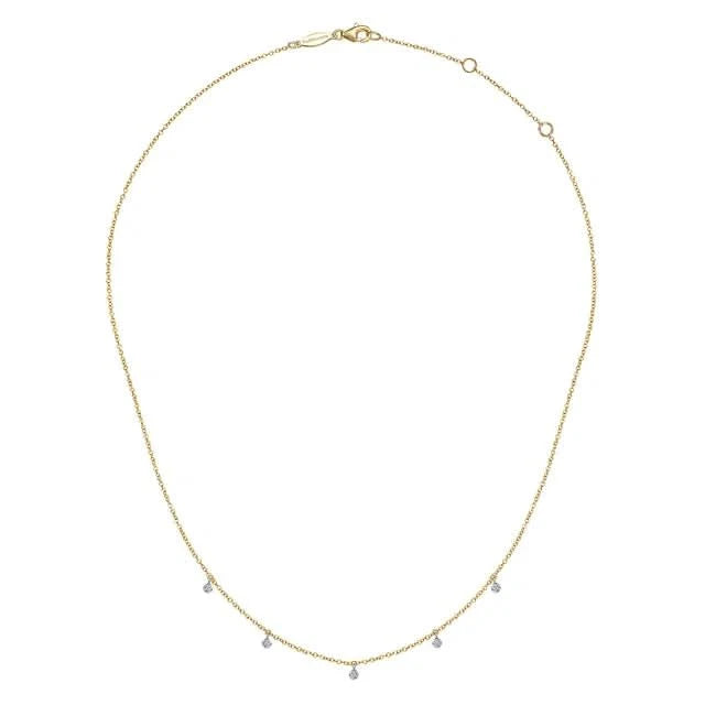 Gold necklace with small beads of diamonds on a white background