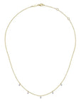 Gold necklace with small beads of diamonds on a white background