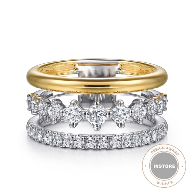 Two diamond-studded rings with a gold band on a white background, featuring an 'INSTORE DESIGN AWARD WINNER' badge.