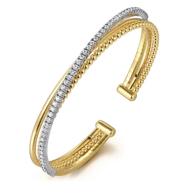 Gold and silver bangle on a white background angled
