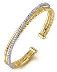 Gold and silver bangle on a white background angled