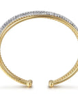Gold and silver bangle on a white background side view