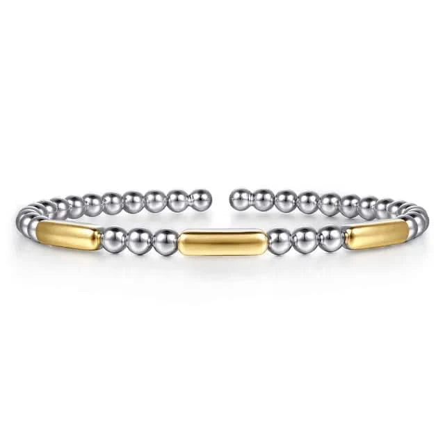 silver beaded bracelets with gold accents on a white background