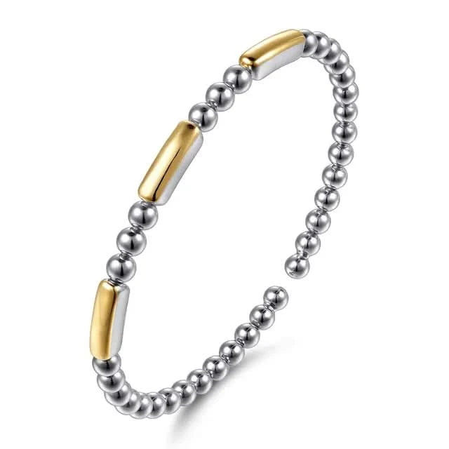 Bracelet with silver beads and gold accents on a white background