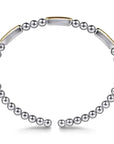 Silver beaded bracelet with gold accents on a white background side view