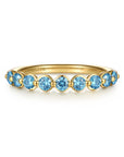 A yellow gold  ring featuring nine round-cut light blue topaz stones, shown on a clean white background. The brand name 'GABRIEL & CO.
