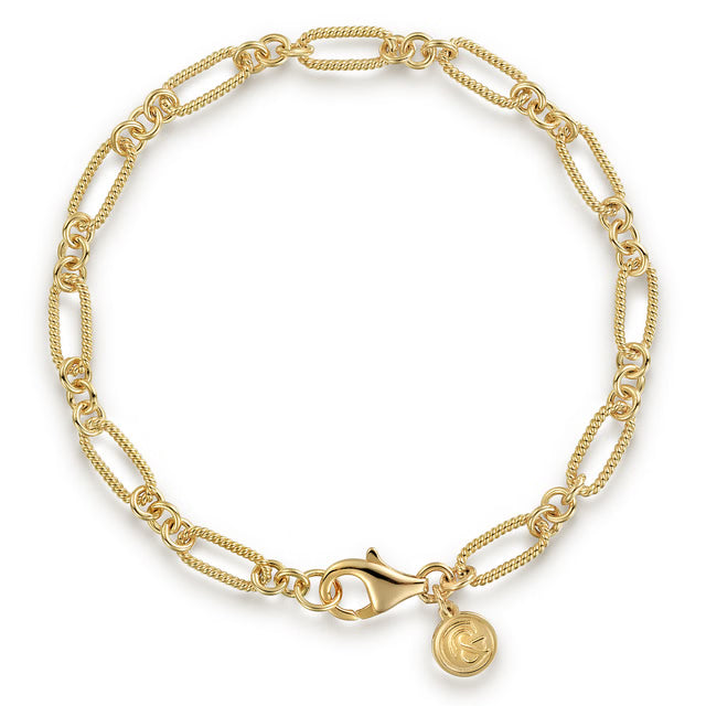 A gold chain bracelet with alternating textured and elongated links, a lobster clasp, and a small round G&amp; logo charm, shown on a clean white background.