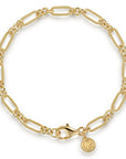 A gold chain bracelet with alternating textured and elongated links, a lobster clasp, and a small round G& logo charm, shown on a clean white background.