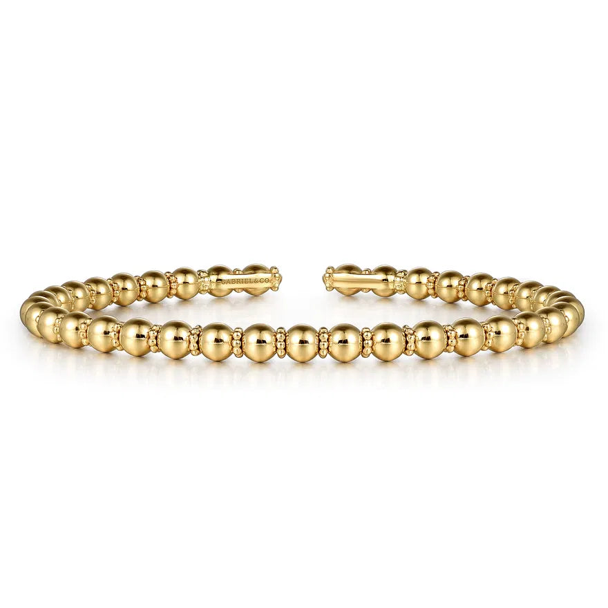  gold beaded bracelet on a white background