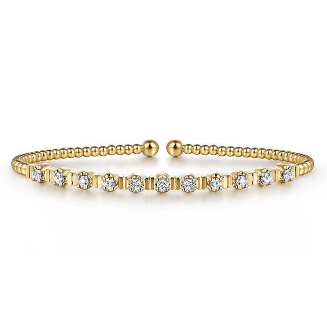 yellow gold bracelet with diamonds and fluted design between each diamond- facing