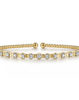 yellow gold bracelet with diamonds and fluted design between each diamond- facing
