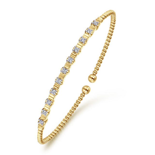 yellow gold bujukan bracelet with diamond stations and fluted designs- angled