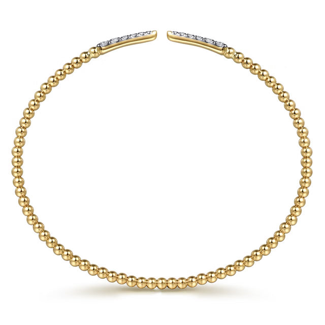 side view of yellow gold beaded open bracelet