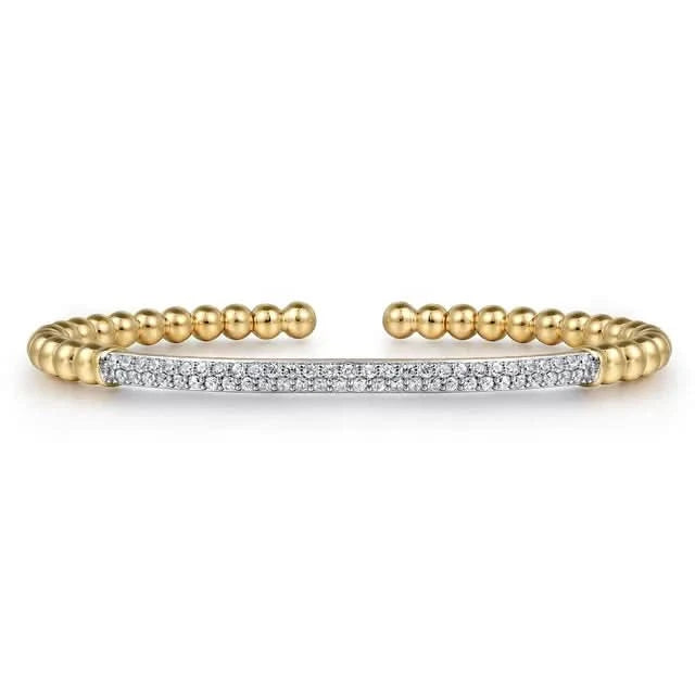 Gold beaded bracelet with a diamond-studded bar on a white background