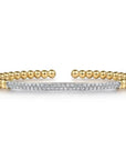 Gold beaded bracelet with a diamond-studded bar on a white background
