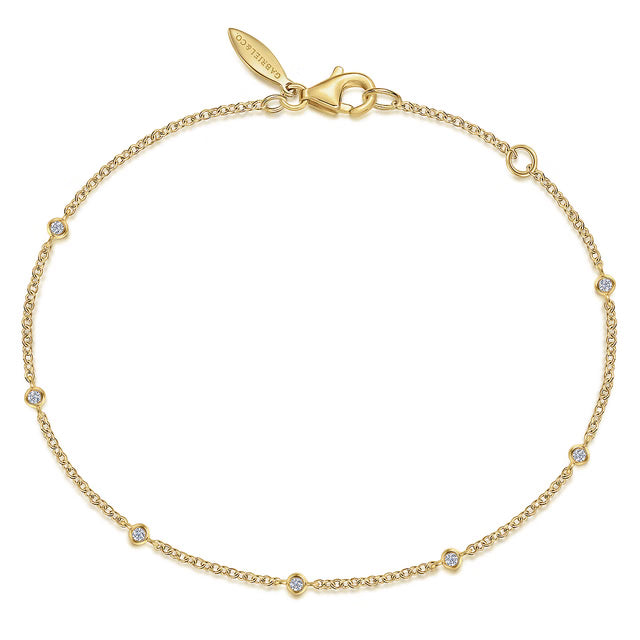 Gold bracelet with small diamonds on a white background