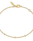 Gold bracelet with small diamonds on a white background