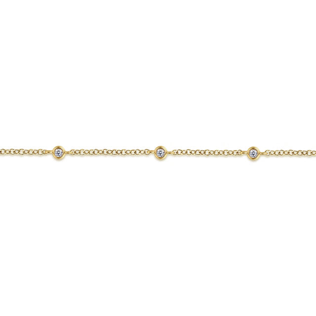 A delicate yellow gold chain bracelet featuring three small bezel-set round clear gemstones spaced evenly along the front, shown against a plain white background. close up