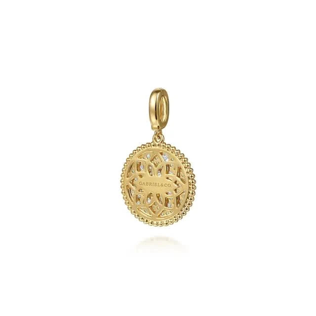 Gold pendant with intricate design on a white background