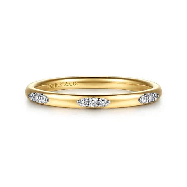 Gold ring with diamonds on a white background